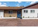 Inviting home exterior with a blue front door, brick accents, desert landscaping, and charming curb appeal at 224 N 58Th St, Mesa, AZ 85205