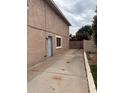 Side yard featuring a private entry gate and spacious area for outdoor activities or storage at 2419 W Crocus Dr, Phoenix, AZ 85023