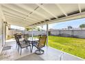Enjoy this backyard with covered patio area that features a table and grill, with a view of the grassy yard at 3553 W El Camino Dr, Phoenix, AZ 85051