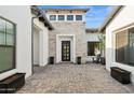 Welcoming home entrance with stone accents, a modern door and decorative landscaping at 4024 E Minton Cir, Mesa, AZ 85215