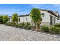 Beautiful home exterior showcasing a well-manicured lawn, stone accents and mature trees at 4024 E Minton Cir, Mesa, AZ 85215