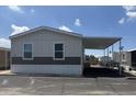 A single story home features neutral colored siding, carport and landscaping under a blue sky at 5601 W Missouri Ave # 150, Glendale, AZ 85301