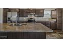 Close-up of kitchen island with stainless appliances and fixtures against white tiled backsplash at 5601 W Missouri Ave # 150, Glendale, AZ 85301