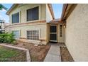 A welcoming front entrance with a secure screen door and a well-maintained landscape at 608 E Arabian Ct, Gilbert, AZ 85296