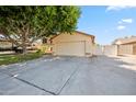 Inviting home featuring an attached two-car garage and a spacious driveway at 608 E Arabian Ct, Gilbert, AZ 85296