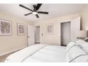 Bright bedroom with ceiling fan featuring neutral walls and a large window letting in natural light at 8103 E Dartmouth St, Mesa, AZ 85207