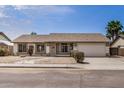 Well-maintained single-story home with a two-car garage and low-maintenance landscaping in front at 8103 E Dartmouth St, Mesa, AZ 85207