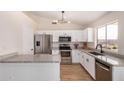 Modern kitchen features stainless steel appliances and granite countertops at 8103 E Dartmouth St, Mesa, AZ 85207