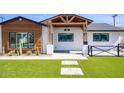 Modern home featuring a black trimmed windows and a well manicured yard at 8318 E Sells Dr, Scottsdale, AZ 85251