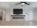 Bright living room featuring a modern fireplace and wood grain tile at 8318 E Sells Dr, Scottsdale, AZ 85251