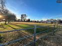 Expansive, well-maintained grassy field, partially fenced, perfect for outdoor activities at 834 E Lockwood St, Mesa, AZ 85203