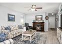 Comfortable living room with a fireplace, ceiling fan, and stylish furnishings at 907 E Kelsi Ave, San Tan Valley, AZ 85140