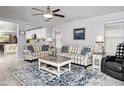 Bright living room featuring a decorative rug, cozy sofas, and ample natural light at 907 E Kelsi Ave, San Tan Valley, AZ 85140