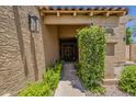 Beautiful home featuring a private walkway leading to the front door with lovely desert landscaping at 9196 E Evans Dr, Scottsdale, AZ 85260