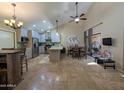 Spacious living room with high ceilings, dining area, and stainless steel appliances in the modern kitchen at 9196 E Evans Dr, Scottsdale, AZ 85260