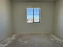 Bright bedroom with a large window offering ample natural light and serene neighborhood views at 9531 W Parkway Dr, Tolleson, AZ 85353