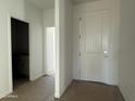 Inviting entryway featuring a solid white door and neutral tones, creating a bright and welcoming atmosphere at 9531 W Parkway Dr, Tolleson, AZ 85353