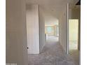 Unfinished hallway featuring new construction with natural light from a window at the end of the hall at 9531 W Parkway Dr, Tolleson, AZ 85353