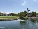 Beautiful view of a lake and golf course showcasing community living with greenery and water features at 9649 S 51 St St, Phoenix, AZ 85044