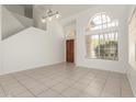 Bright, open living room with tile floors, neutral walls and front door view at 9649 S 51 St St, Phoenix, AZ 85044
