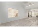 Bright, open living room with tile floors, neutral walls, and modern lighting at 9649 S 51 St St, Phoenix, AZ 85044