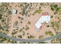 Aerial view of expansive home, detached garage, and well-maintained grounds surrounded by desert landscape at 10600 E Cordova St, Gold Canyon, AZ 85118