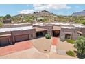 Expansive home with Southwestern architecture, multiple garages, desert landscaping, and mountain views at 10600 E Cordova St, Gold Canyon, AZ 85118