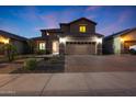 Charming two-story home boasts a well-maintained front yard, a brick driveway, and a welcoming entrance at 10746 W Desert Elm Ln, Peoria, AZ 85383
