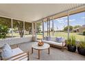 Relaxing sunroom with comfortable seating to enjoy the views of the community green space at 10839 W Peoria Ave, Sun City, AZ 85351