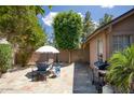 Inviting backyard featuring a patio with a table and chairs, complemented by lush greenery at 1117 W Manor St, Chandler, AZ 85224
