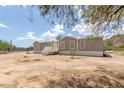 Charming single story home featuring neutral paint, contrasting trim and mature trees at 11912 N Thunderbird Rd, Maricopa, AZ 85139