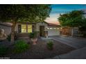 Attractive home with a two-car garage and manicured front yard with desert landscaping at 1344 N Claiborne --, Mesa, AZ 85205