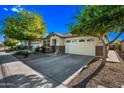 Beautiful single-Gathering home featuring a well-kept lawn and a concrete driveway at 1344 N Claiborne --, Mesa, AZ 85205