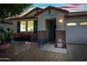 Inviting front entrance featuring stone accents and a covered porch with warm lighting at 1344 N Claiborne --, Mesa, AZ 85205
