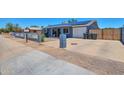 The exterior with the driveway, garage and fenced front yard at 13913 N 2Nd Ave, El Mirage, AZ 85335