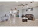 Open-concept living room with tile flooring and a view of the updated kitchen at 13913 N 2Nd Ave, El Mirage, AZ 85335