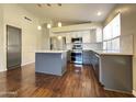 Modern kitchen with stainless steel appliances, granite countertops, and a kitchen island at 1463 E Silver Creek Rd, Gilbert, AZ 85296