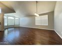 Spacious living room with hardwood floors, lots of natural light, and vaulted ceilings at 1463 E Silver Creek Rd, Gilbert, AZ 85296