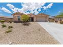 Charming single-story home with a well-maintained yard and spacious two-car garage at 15248 S 182Nd Ln, Goodyear, AZ 85338