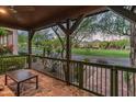 Inviting covered patio with stone flooring, providing serene views of the green neighborhood at 17728 N 92Nd Pl, Scottsdale, AZ 85255