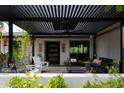 Relaxing covered patio space with comfortable seating and a tranquil water fountain feature at 1861 W Navarro Ave, Mesa, AZ 85202