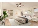 Spacious bedroom featuring a plush bed, natural light, and minimalist decor for a serene retreat at 19697 N 66Th Ave, Glendale, AZ 85308