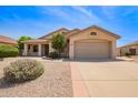 Charming single-story home with a two-car garage and low maintenance desert landscaping at 19697 N 66Th Ave, Glendale, AZ 85308