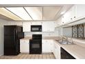 Bright kitchen with white cabinetry and black appliances for a clean, modern feel at 205 N 74Th St # 248, Mesa, AZ 85207