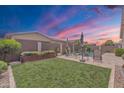 Lush backyard featuring a manicured lawn, mature trees, and privacy fence that is ideal for outdoor relaxation at 22927 E Via Del Oro --, Queen Creek, AZ 85142