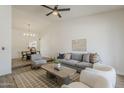 Bright living room boasting vaulted ceilings, modern furnishings, and wood-look tile floors at 2307 W Nido Ave, Mesa, AZ 85202