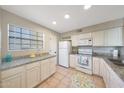 Bright kitchen features granite countertops, white cabinets, and appliances at 2333 E Southern Ave # 1049, Tempe, AZ 85282