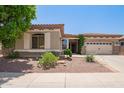 Inviting single-story home featuring a well-maintained front yard and a two-car garage, all under a sunny sky at 2413 W Kachina Trl, Phoenix, AZ 85041