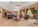Open-concept living room featuring carpet, armchairs, a sofa, and a view of the kitchen and eating area at 2413 W Kachina Trl, Phoenix, AZ 85041