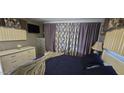 Bright bedroom with white furniture, and colorful patterned curtains at 25 S 102Nd St # 92, Mesa, AZ 85208